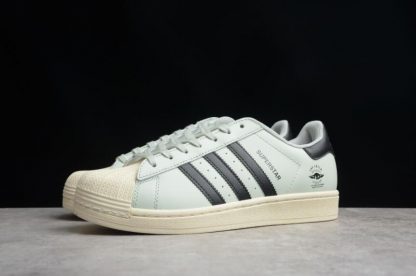 black adidas trainers with white stripes on back